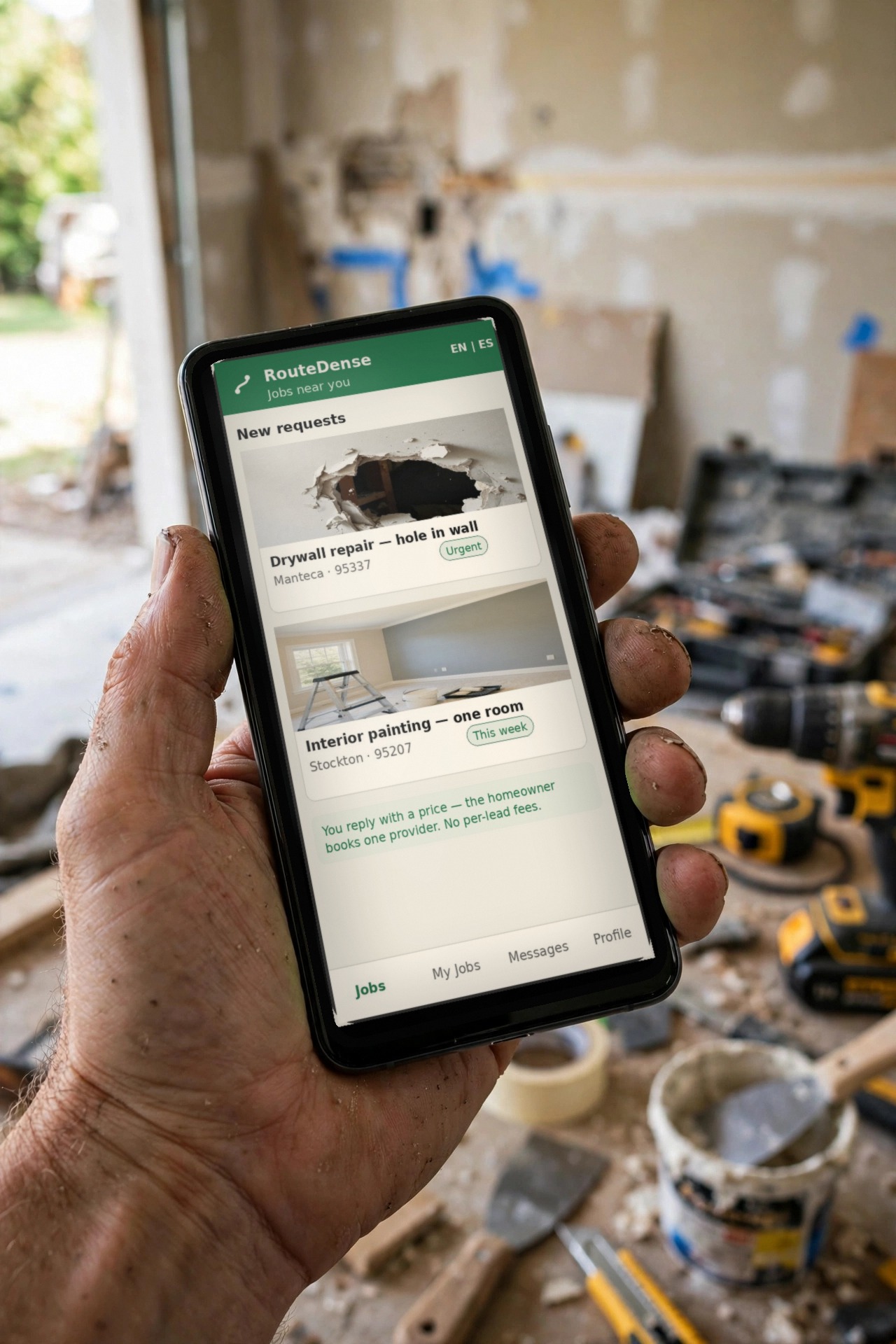 The RouteDense app on a phone in a handyman's hand, showing jobs near you.
